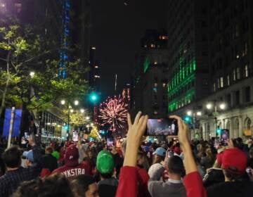 Fans celebrate on Broad Street on Oct. 23, 2022 after the Philadelphia Phillies clinch the pennant.