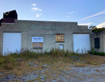 Trump-Pence sign hangs on a building off of Main Street in Monongahela, Pa., on Sept. 23, 2022. The sign is a lasting vestige of the campaign fervor that roused voters to the polls, including many who still believe the falsehood that the former president didn’t lose the 2020 election and hope he will run again in 2024. (AP Photo/Lisa Mascaro)