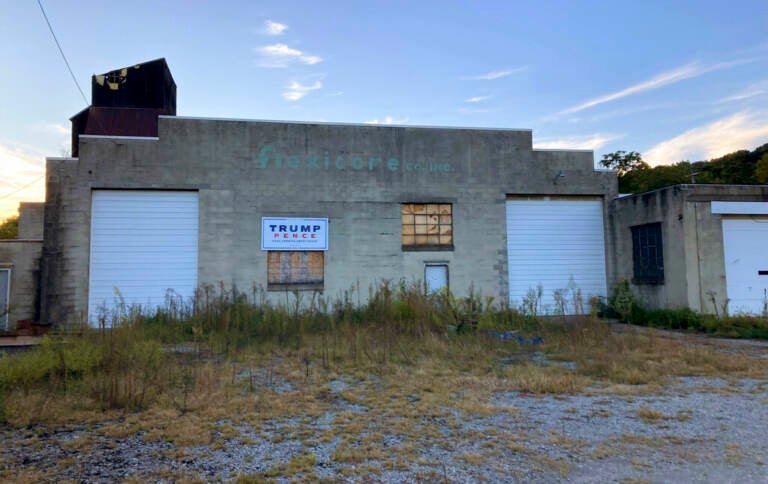 Trump-Pence sign hangs on a building off of Main Street in Monongahela, Pa., on Sept. 23, 2022. The sign is a lasting vestige of the campaign fervor that roused voters to the polls, including many who still believe the falsehood that the former president didn’t lose the 2020 election and hope he will run again in 2024. (AP Photo/Lisa Mascaro)