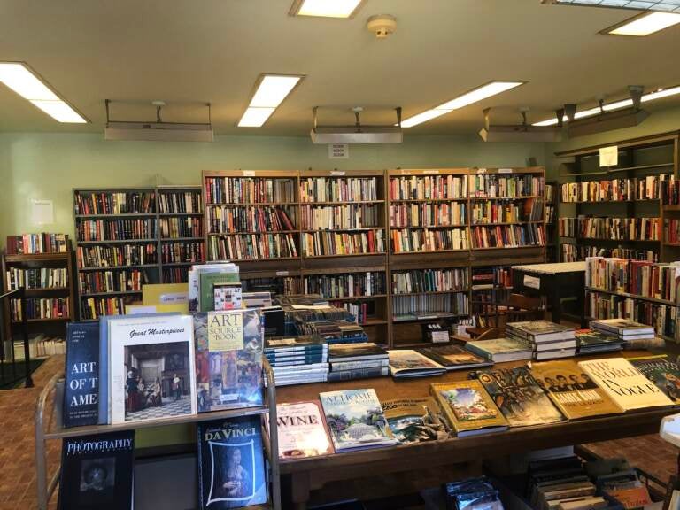 Books are arranged on booshelves and tables.