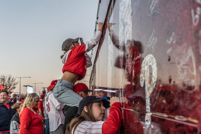 Phillies fans were invited to sign the team’s tour bus outside Citizens Bank in Philadelphia before game 3 of the World Series on November 1, 2022. (Kimberly Paynter/WHYY)