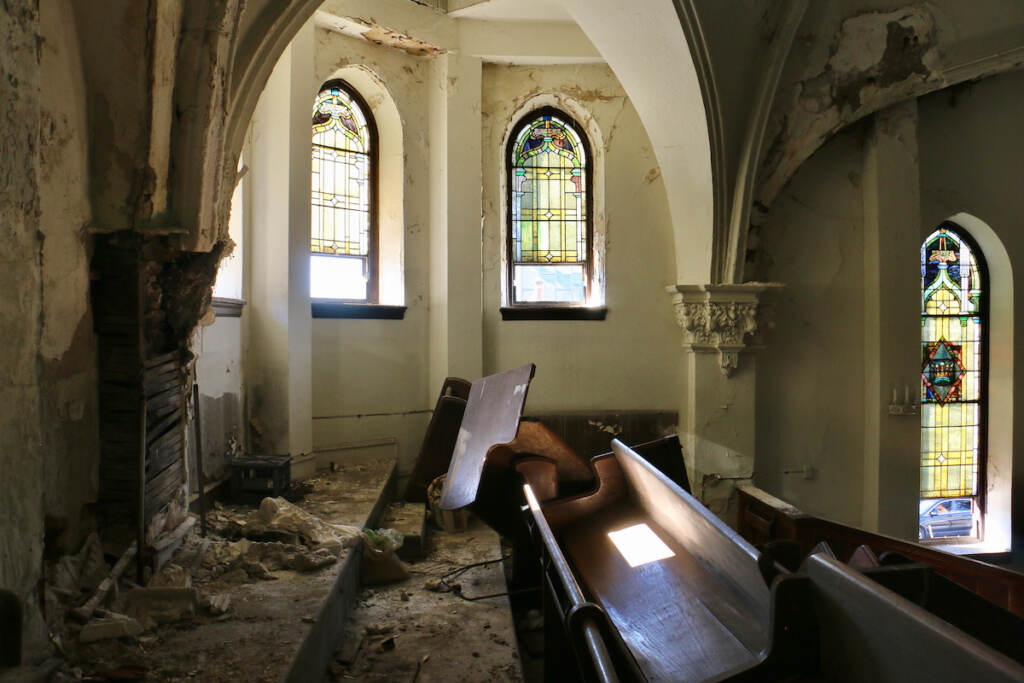 A balcony in need of repair is visible.