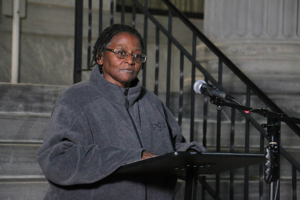 A woman stands at a podium.