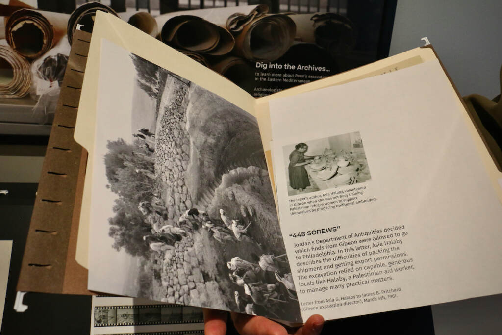 A book is open with a black-and-white photo visible.