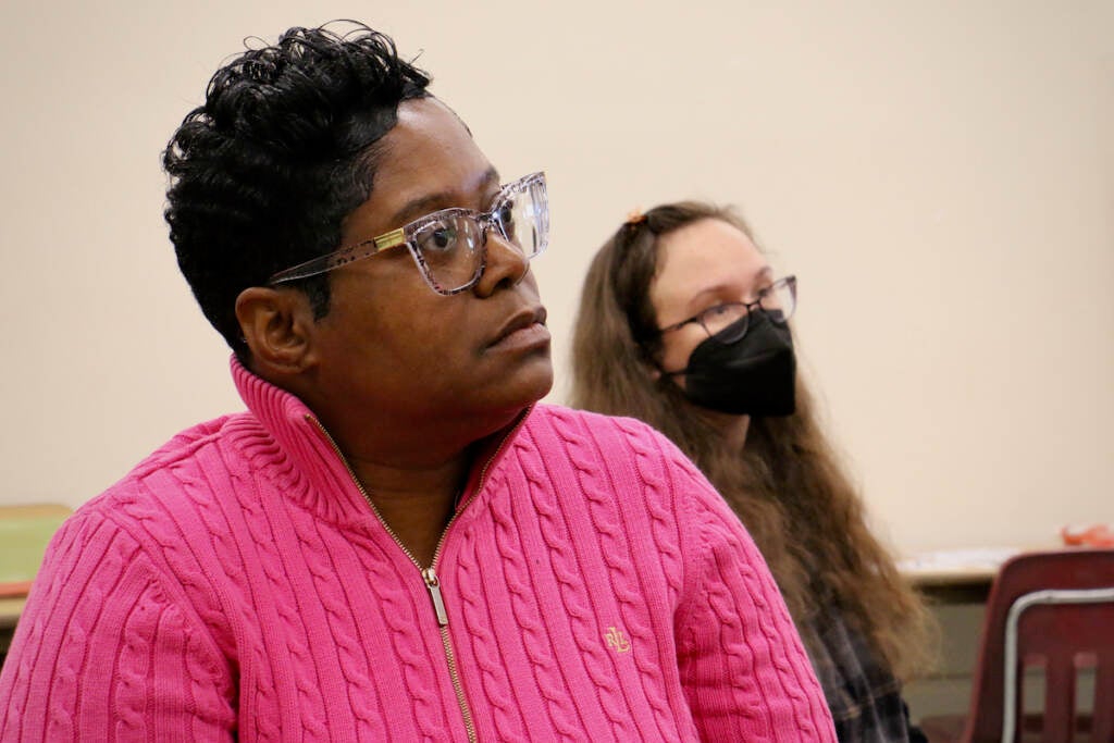 A close-up of a woman listening intently.