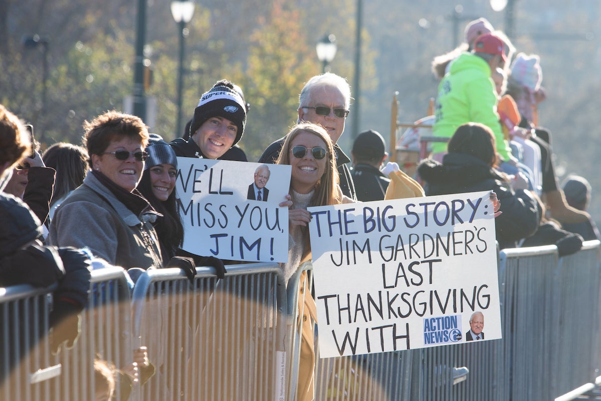 Lauren Eccleston (right) and John Gentile and friends came from Somers Point, New Jersey to celebrate the career of Jim Gardner at the 103rd Philadelphia Thanksgiving Day Parade. (Emily Cohen for WHYY)