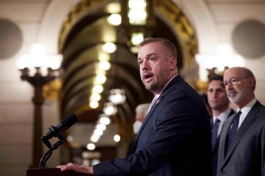 A man speaks at a podium.