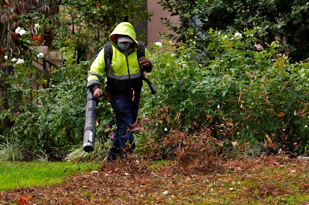 California Air Quality File: A gardener uses a leaf blower to clear leaves at a home in Sacramento, Calif., on Oct. 13, 2021.