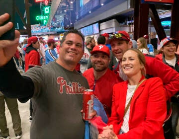 Jayme Hoskins, right, wife of Philadelphia Phillies first baseman Rhys Hoskins, poses with fans at Game 4 of the baseball World Series between the Phillies and the Houston Astros on Wednesday. Nov. 2, 2022, in Philadelphia. Hoskins tweeted she would buy fans beer before the game at Section 104 of the stadium. She paid for about 100 beers. (AP Photo/Daniel Gelston)