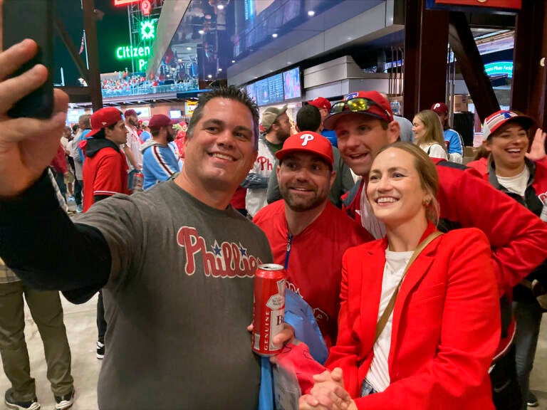 Jayme Hoskins, right, wife of Philadelphia Phillies first baseman Rhys Hoskins, poses with fans at Game 4 of the baseball World Series between the Phillies and the Houston Astros on Wednesday. Nov. 2, 2022, in Philadelphia. Hoskins tweeted she would buy fans beer before the game at Section 104 of the stadium. She paid for about 100 beers. (AP Photo/Daniel Gelston)