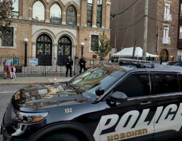 Hoboken Police officers stand watch outside the United Synagogue of Hoboken, Thursday, Nov. 3, 2022, in Hoboken, N.J. The FBI says it has received credible information about a threat to synagogues in New Jersey. The FBI's Newark office released a statement Thursday afternoon that characterizes it as a broad threat. The statement urged synagogues to 