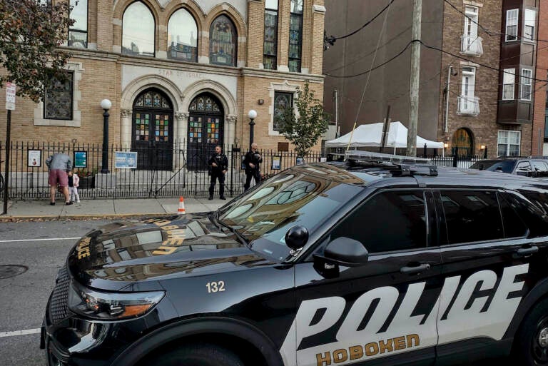 Hoboken Police officers stand watch outside the United Synagogue of Hoboken, Thursday, Nov. 3, 2022, in Hoboken, N.J. The FBI says it has received credible information about a threat to synagogues in New Jersey. The FBI's Newark office released a statement Thursday afternoon that characterizes it as a broad threat. The statement urged synagogues to 