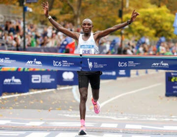 Evans Chebet, of Kenya, crosses the finish line first in the men's division of the New York City Marathon, Sunday, Nov. 6, 2022, in New York. (AP Photo/Jason DeCrow)