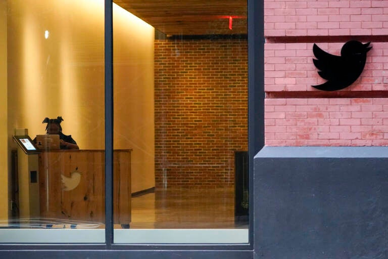 FILE - A receptionist works in the lobby of the building that houses the Twitter office in New York, Wednesday, Oct. 26, 2022. Elon Musk has emailed Twitter employees ordering them to return to the office starting Thursday for at least 40 hours a week and warning of “difficult times ahead.”  (AP Photo/Mary Altaffer)