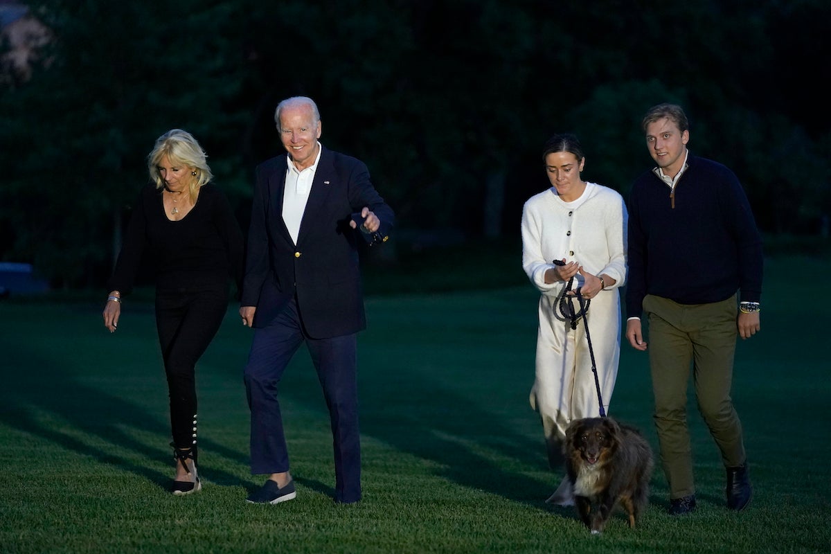 File photo: President Joe Biden and fist lady Jill Biden, left, walk with their granddaughter Naomi Biden, second from right, and her fiancé Peter Neal, right, and Neal's dog Charlie, across the South Lawn of the White House in Washington, June 20, 2022, as they return from a weekend at the Biden's beach home in Delaware. (AP Photo/Susan Walsh, File)