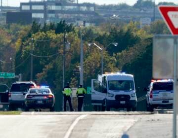 Emergency responders stage near Dallas Executive Airport where two historic military planes collided and crashed during an airshow, Saturday, Nov. 12, 2022. (AP Photo/LM Otero)