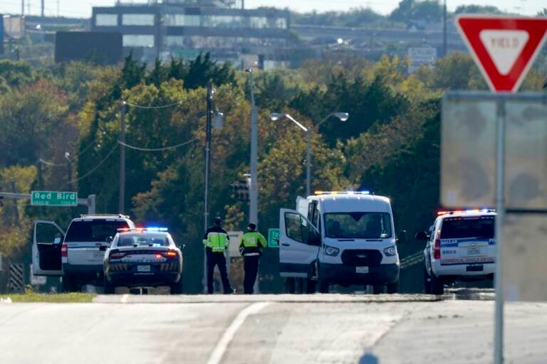 Emergency responders stage near Dallas Executive Airport where two historic military planes collided and crashed during an airshow, Saturday, Nov. 12, 2022. (AP Photo/LM Otero)