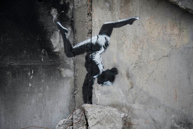 An artwork by British street artist Banksy is seen on a destroyed by fightings building in Borodyanka, Kyiv region, Ukraine, Sunday, Nov. 13, 2022. (AP Photo/Andrew Kravchenko)