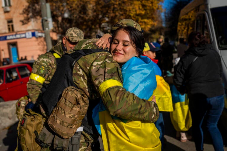A Kherson resident hugs a Ukrainian defence force member in Kherson, southern Ukraine, Monday, Nov. 14, 2022. The retaking of Kherson was one of Ukraine's biggest successes in the nearly nine months since Moscow's invasion. (AP Photo/Bernat Armangue)
