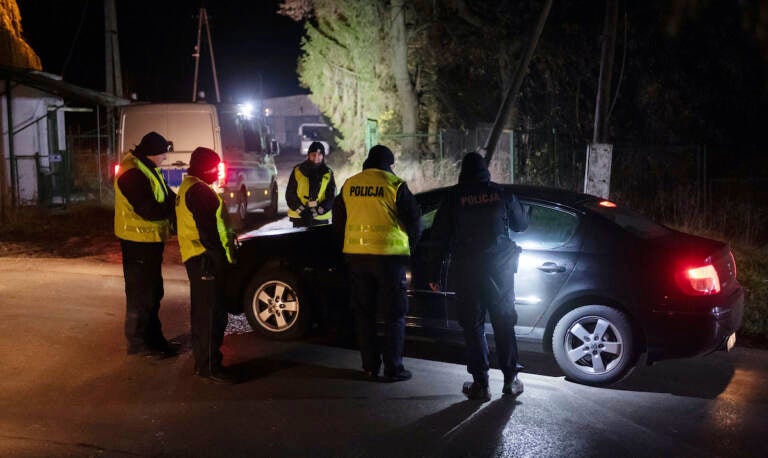 Police officers gather outside a grain depot in Przewodow, eastern Poland, on Tuesday Nov. 15, 2022 where the Polish Foreign Ministry said that a Russian-made missile fell and killed two people. (AP Photo)