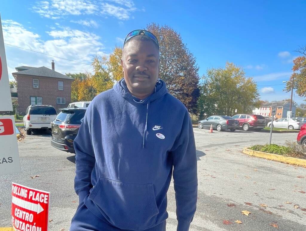 A man poses outside of a polling station.