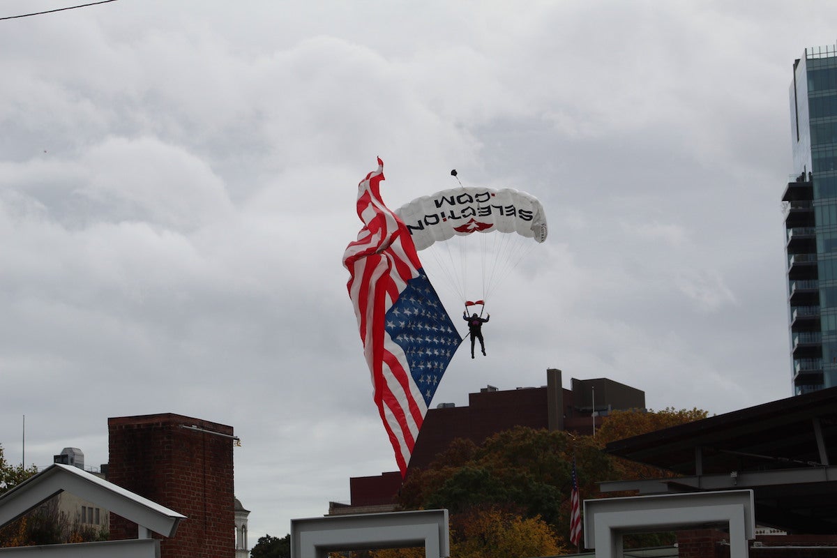 A parachutist gets ready to land near Independence Hall at the 2022 Philadelphia Veterans Parade. (Cory Sharber/WHYY)