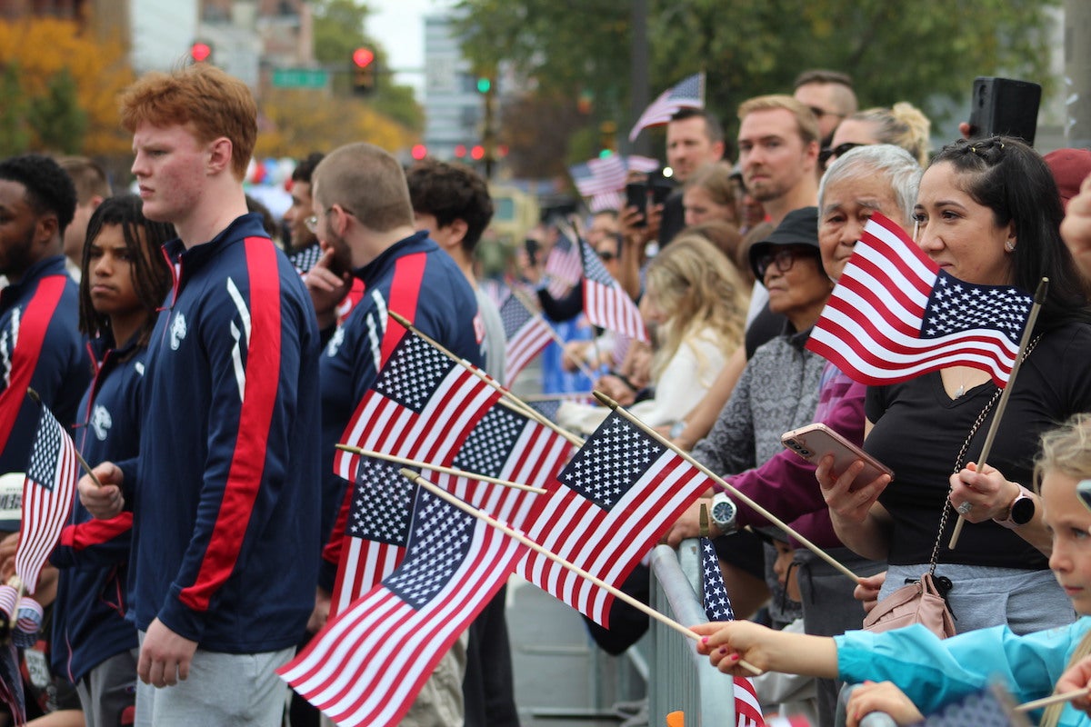 Parade attendees lined up on sidewalks along Market St. on Sunday. (Cory Sharber/WHYY)