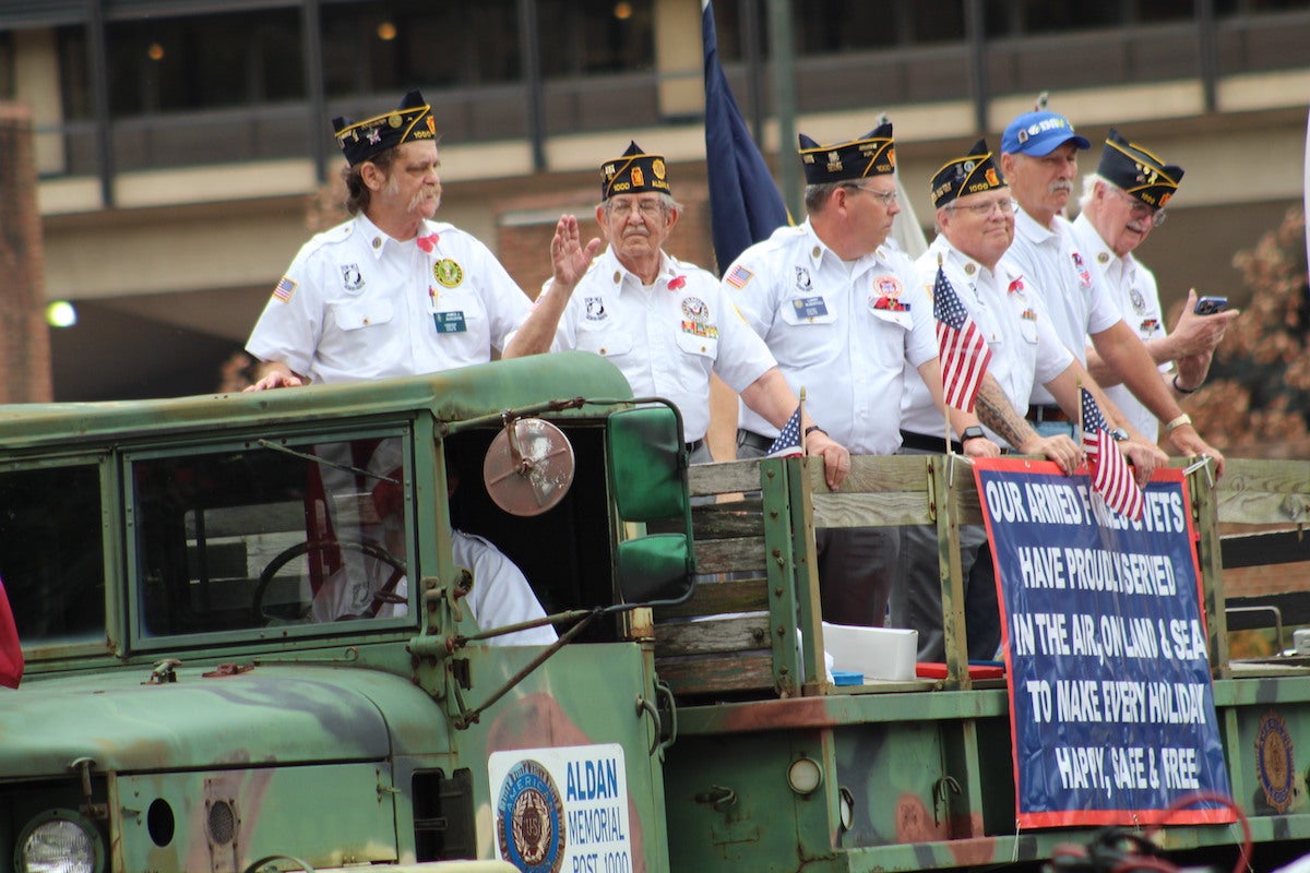 Veterans waved at parade goers and connected with old friends on floats during the 2022 Philadelphia Veterans Parade on Nov. 6. (Cory Sharber/WHYY)