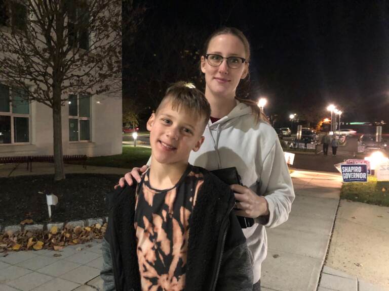 Caitlin Frazier, 29, with her 9-year-old son Noah. Frazier usually votes red, but said this year her ballot is mostly blue. (Emily Rizzo/WHYY)