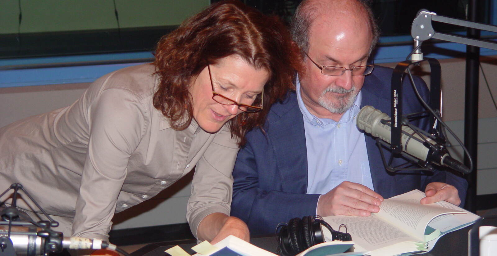 Marty Moss-Coane and Salman Rushdie hold open books next to one another