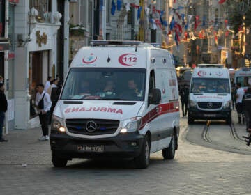 Security and ambulances report to the scene of an explosion on Istanbul's popular pedestrian Istiklal Avenue on Sunday. At least four people were killed. (Francisco Seco/AP)