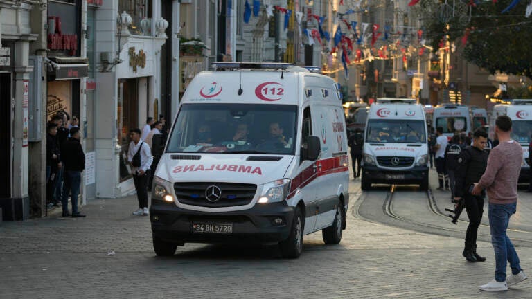 Security and ambulances report to the scene of an explosion on Istanbul's popular pedestrian Istiklal Avenue on Sunday. At least four people were killed. (Francisco Seco/AP)