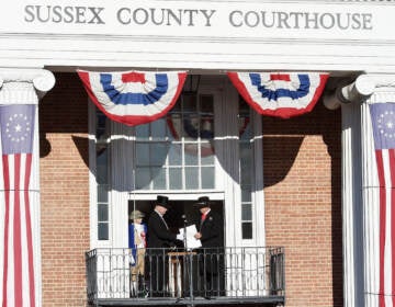 Sussex County Sheriff Robert Lee, right, hands the election results to Georgetown Town Crier Kirk Lawson as Sussex County Return Day in 2018. (Delaware State News / Chuck Snyder)
