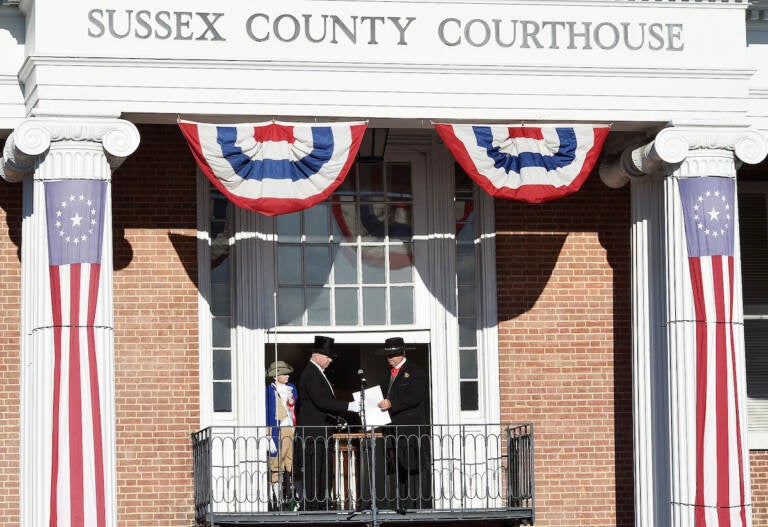 Sussex County Sheriff Robert Lee, right, hands the election results to Georgetown Town Crier Kirk Lawson as Sussex County Return Day in 2018. (Delaware State News / Chuck Snyder)