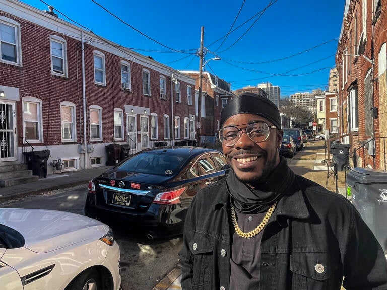 Davian Green smiles for a photo on an East Side sidewalk