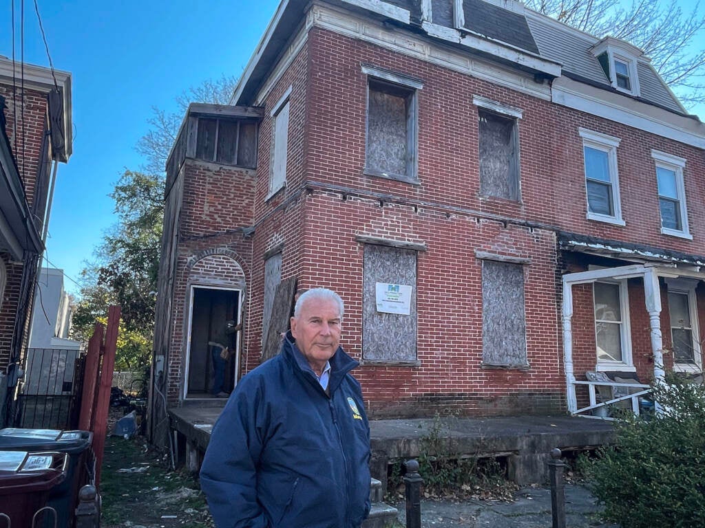 Mayor Mike Purzycki stands outside a long-abandoned home now being renovated.