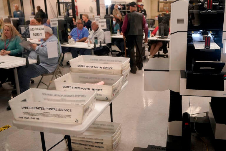 Adjudicators observe as ballots are tabulated inside the Maricopa County Recorders Office, Wednesday, Nov. 9, 2022, in Phoenix. (AP Photo/Matt York)