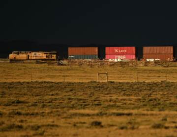 A Union Pacific freight train carries cargo along a rail line at sunset in Bosler, Wyoming, on August 13, 2022. (Patrick T. Fallon/AFP via Getty Images)