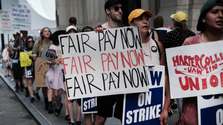 HarperCollins employees on a one-day strike earlier this summer. Workers have been in negotiations with the company since December 2021. (Spencer Platt/Getty Images)