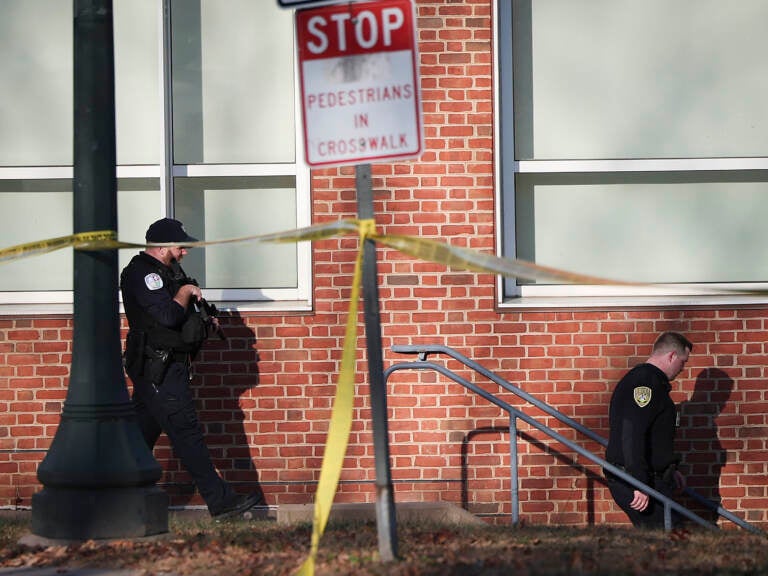 Law enforcement personnel move through the crime scene. (Win McNamee/Getty Images)