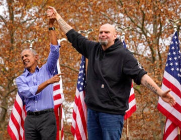 Former President Barrack Obama, left, finishes his remarks and welcomes Pennsylvania Lt. Gov. John Fetterman, a Democratic candidate for U.S. Senate, to the stage during a campaign rally in Pittsburgh, Saturday, Nov. 5, 2022.