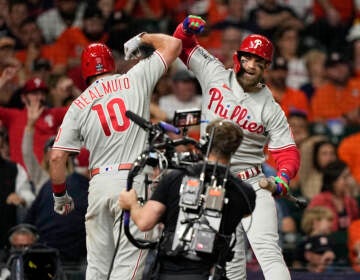 J.T. Realmuto celebrates his home run during the 10th inning in Game 1 of the World Series