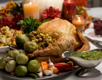 A grill-roasted brined turkey is presented on a table