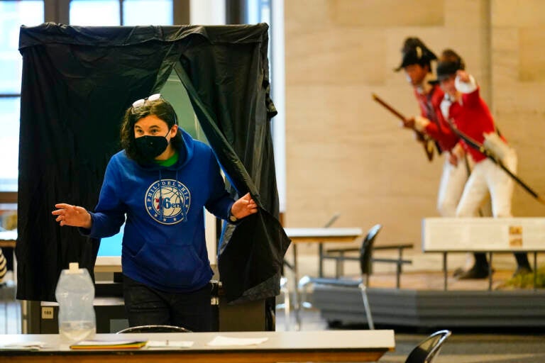 A voter steps from a booth after casting a ballot