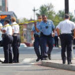 A group of police officers gathered on a street corner.