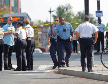 A group of police officers gathered on a street corner.