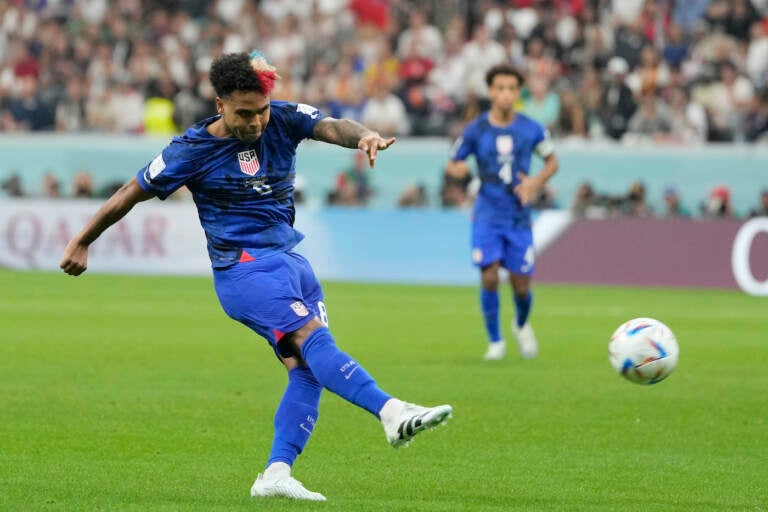Weston McKennie of the United States kicks the ball during the World Cup group B soccer match between England and The United States, at the Al Bayt Stadium in Al Khor, Qatar, Friday, Nov. 25, 2022. (AP Photo/Andre Penner)