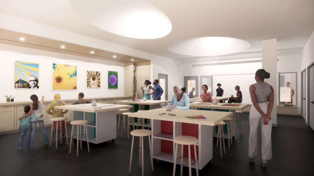 A rendering shows an art studio filled with people.