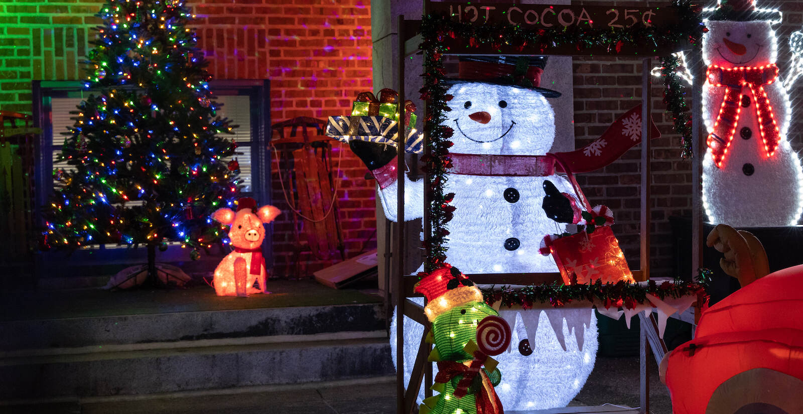 Blow-up characters and holiday lights are seen outside the Chandler School