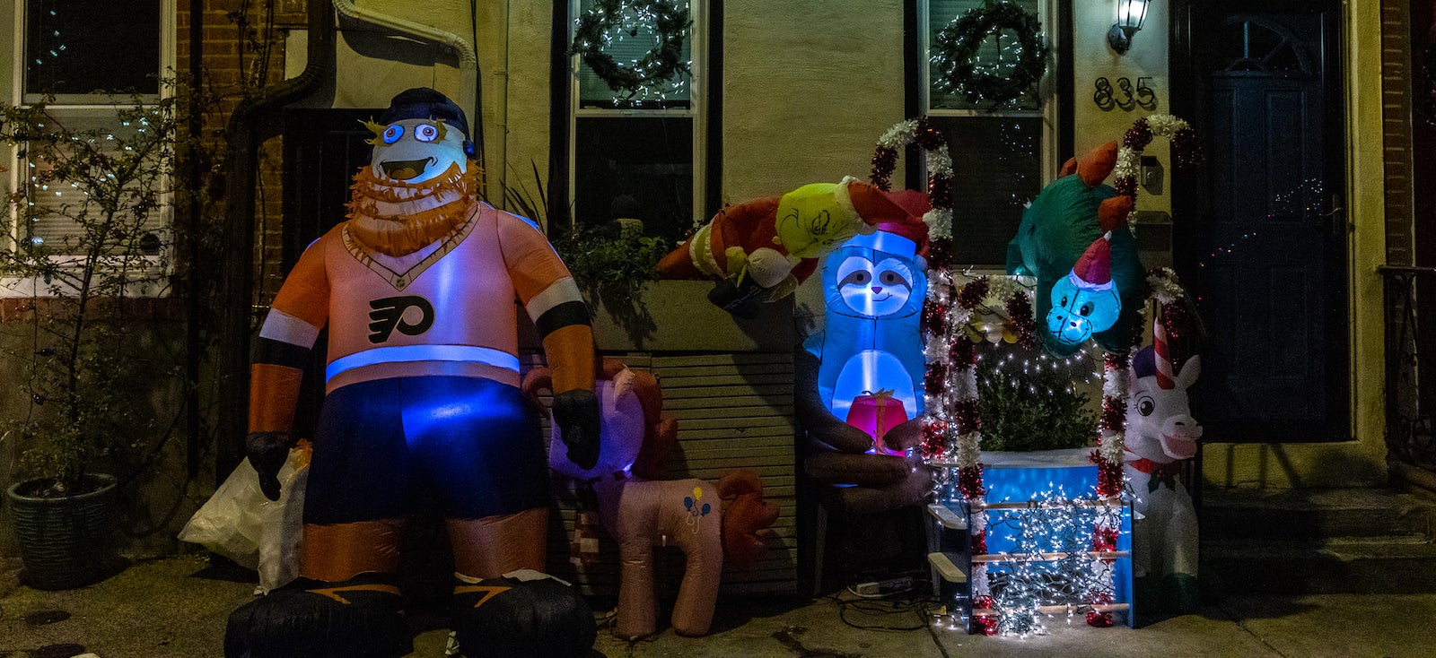 A blow-up Gritty appears amid holiday decorations outside a South Philly rowhouse